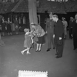 A young Dutch girl presenting flowers to Ingrid of Sweden at Keukenhof, the Netherlands, April 1954.