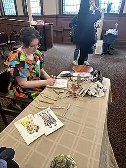 Portrait artist at the reception area at the Big Gay Wedding event