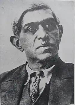 Black and white portrait photograph of a man wearing a suit
