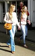 Image 71Two women wearing flared trousers, jeggings and oversized cardigans, 2011. (from 2010s in fashion)