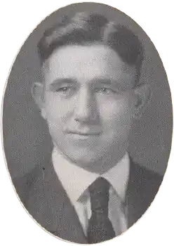 A young man facing camera wearing a suit coat and tie