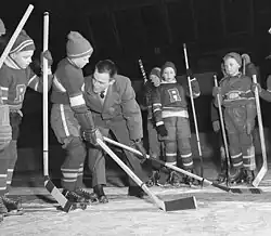 Coach demonstrating skill to players
