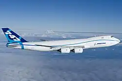 Side view of quadjet over clouds