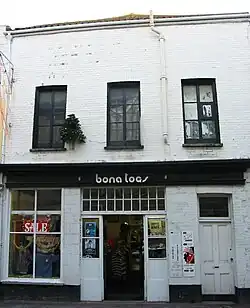 Storefront with "Bona Togs" signage in white letters on a dark background