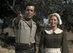 Pernell Roberts and Patricia Donahue in a black-and-white TV scene.