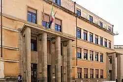 Large institutional building in Fascist-era architectural style.