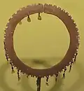 A bracelet made of brass, beads and mother of pearl