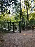 Photo of the bridge people use to cross over Peach Creek.