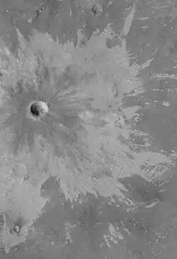 Bright rays caused by impact throwing out a bright lower layer. Some bright layers contain hydrated minerals. Picture taken by Mars Global Surveyor. Location is Memnonia quadrangle.