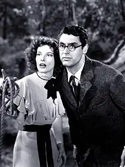 Katharine Hepburn and Cary Grant (in round glasses), looking off-screen