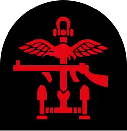Insignia of Combined Operations units it is a combination of a red Thompson submachine gun, a pair of wings, an anchor and mortar rounds on a black backing