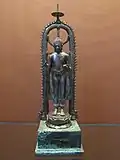 Silver standing Buddha under a parasol