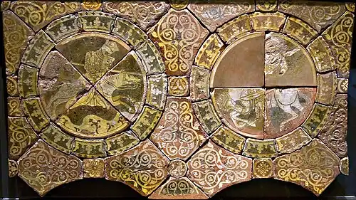 Fragmented tiles depicting two warriors, each riding a horse, one of them, fully armored with a lance in his right hand, wears a crown, and the other holds a sword in his left hand