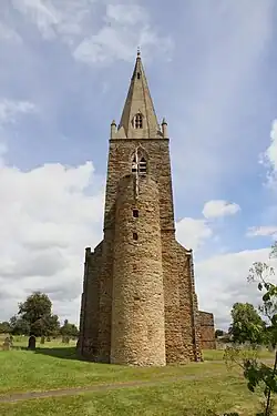 All Saints' Church seen from the west. The stair turret is 10th-century; the spire and upper stages of the tower are 14th-century.