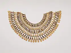 Broad Collar of Nefer Amulets from the Tomb of the Three Foreign Wives of Thutmose III, c. 1504–1450 BC, gold, glass, Egyptian blue, Metropolitan Museum of Art.