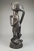 Figurine of a standing woman; late 19th or early 20th century; wood; 27.9 × 8.3 × 10.2&nbsp;cm (11 × 31⁄4 × 4 in.); Brooklyn Museum (New York City)