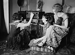 Image 20Around 1920, radio broadcasting started to get popular. The Brox Sisters, a popular singing group, gathered around the radio at the time. (from History of radio)