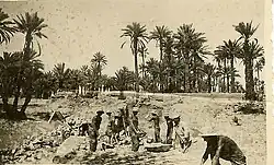 Workers apparently constructing an embankment