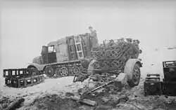 January 1944 on the Russian front. Soldiers unload ammunition from a light ammunition transport vehicle (Zugkraftwagen 3t (Sd.Kfz. 11)) for a 28/32cm caliber Nebelwerfer.
