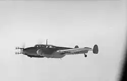 A twin engine propeller driven aircraft in flight.