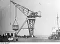 Crane located in Tsingtao China. Giant crane supplied by Demag. During the war a large blast destroyed the foundation dumping the crane in the sea, where it remained for 5 years, until the Japanese brought it up again, and repaired the systems completely.