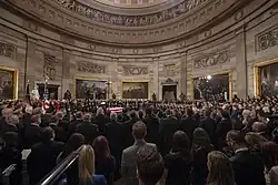 Mourners circumambulate the casket of George Bush during the lying in state on December 3, 2018