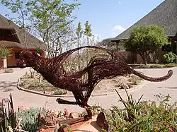 A cheetah sculpture in front of two buildings at the Cheetah Conservation Fund's Field and Research Centre in Otjiwarongo, Namibia