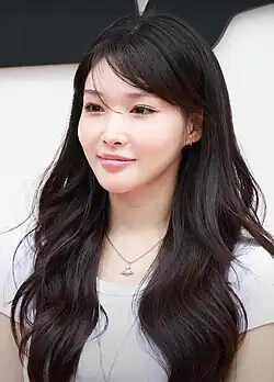 Chung Ha posing on a press photo line for a brand event