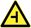 Side road junction ahead (Left)