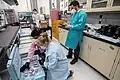 Scientists and students working on SpaceX CRS-21 returned science experiments in the SSPF lab workshop, January 2021