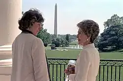 two women on the Truman balcony looking at the Washington Monument.