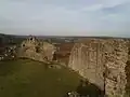 A ruined wall on a hilltop.