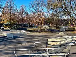 Concrete skate park featuring rails and ramps.