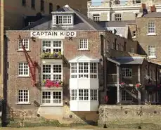 Brown building with white windows and the pub name in all black capital letters.