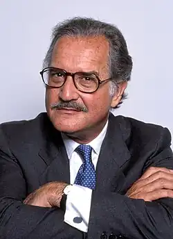 Head photo of a greying man with a small moustache.