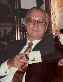 Photograph of Carlos Rangel, sitting, arms crossed c. 1976