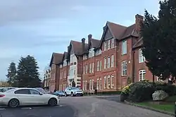 The Old School, seen from what was the original approach through the Lodge with the ancient Harestone to the right. 'Harestone' is a school house at Caterham.