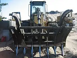The front of a Caterpillar 930G fitted with loader rake