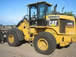 A Caterpillar 930G fitted with a loader rake on a residential construction site in South Florida