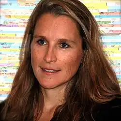 Professional headshot of Catherine Gund at the Tribeca Film Festival in New York City. She has short hair and is wearing a black shirt.