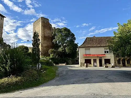 Central square of the hamlet of Clérans with the donjon of the Château de Clérans on the left