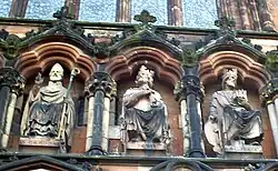 St Chad (left), alongside Mercian kings Peada and Wulfhere, as portrayed in 19th-century sculpture above the western entrance to Lichfield Cathedral