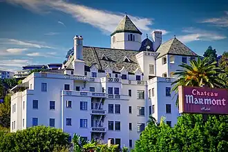 View of Chateau Marmont hotel building from Sunset Boulevard, showing a multi-story French château-style structure