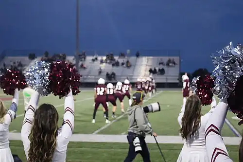 Cheyenne Mountain cheerleaders and football players during a football game