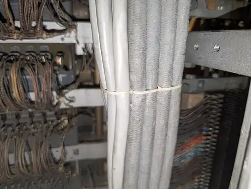 Cables laced together in a bundle using a Chicago stitch. In this case, the cables are not secured to a structure, but the cable lacing is used to keep them in a rectangular form in the riser.