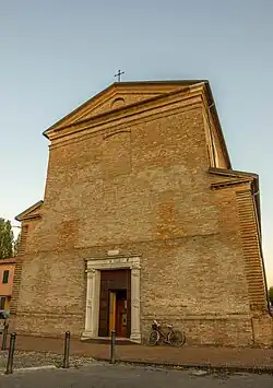 A windowless front face of an Italian church