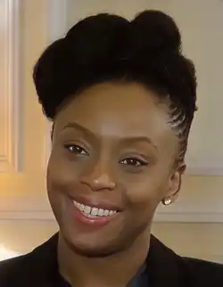 A shoulder cut portrait of a black woman, smiling