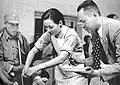 Soong giving a bandage to an injured Chinese soldier (c. 1942)[54]