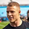 Headshot of McCaffrey wearing a black shirt