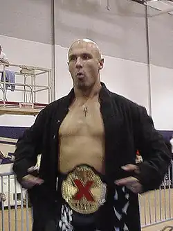 Christopher Daniels with the original design of the X-Division Championship belt.